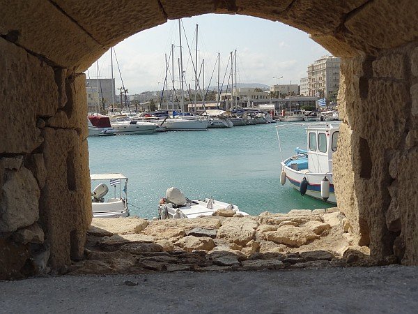 Heraklion harbour through hole in wall near Koules fortress