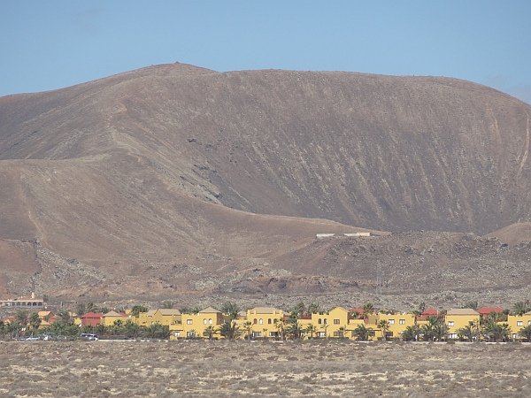 Houses in front of volcano near Corralejo