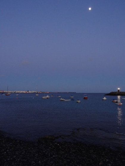 Illuminated beach at night near Playa Blanca harbour