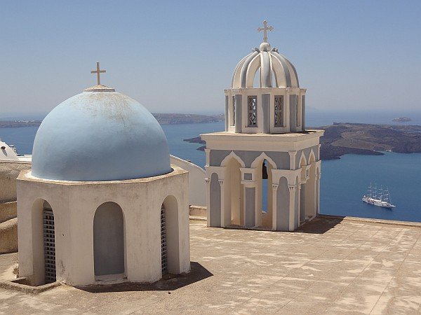 Church with bell tower in Firostefani against caldera backdrop