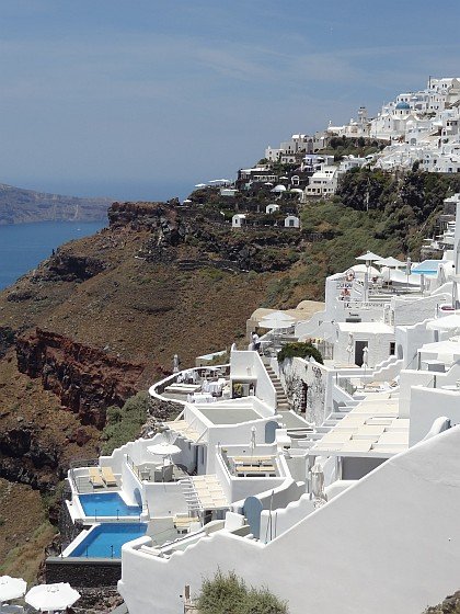 Firostefani cliff edge properties; in backgroud Imerovigli