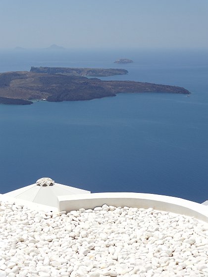 White pebbled roof in Firostefani against caldera backdrop