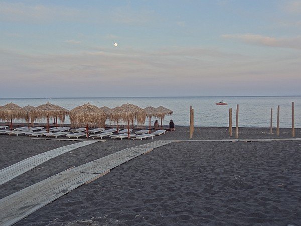 Perivolos beach after dusk with rising moon