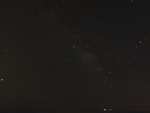 Night sky at Milicias beach (showing centre of Milky Way galaxy; the 3 brightest objects are Mars (left), Saturn (middle) and Antares (α Scorpii; right); the two bright objects at the bottom are moving ships)