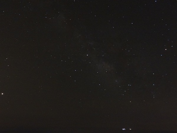 Night sky at Milicias beach (showing centre of Milky Way galaxy; the 3 brightest objects are Mars (left), Saturn (middle) and Antares (α Scorpii; right); the two bright objects at the bottom are moving ships)